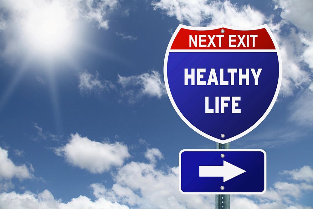 A road sign that says next exit healthy life